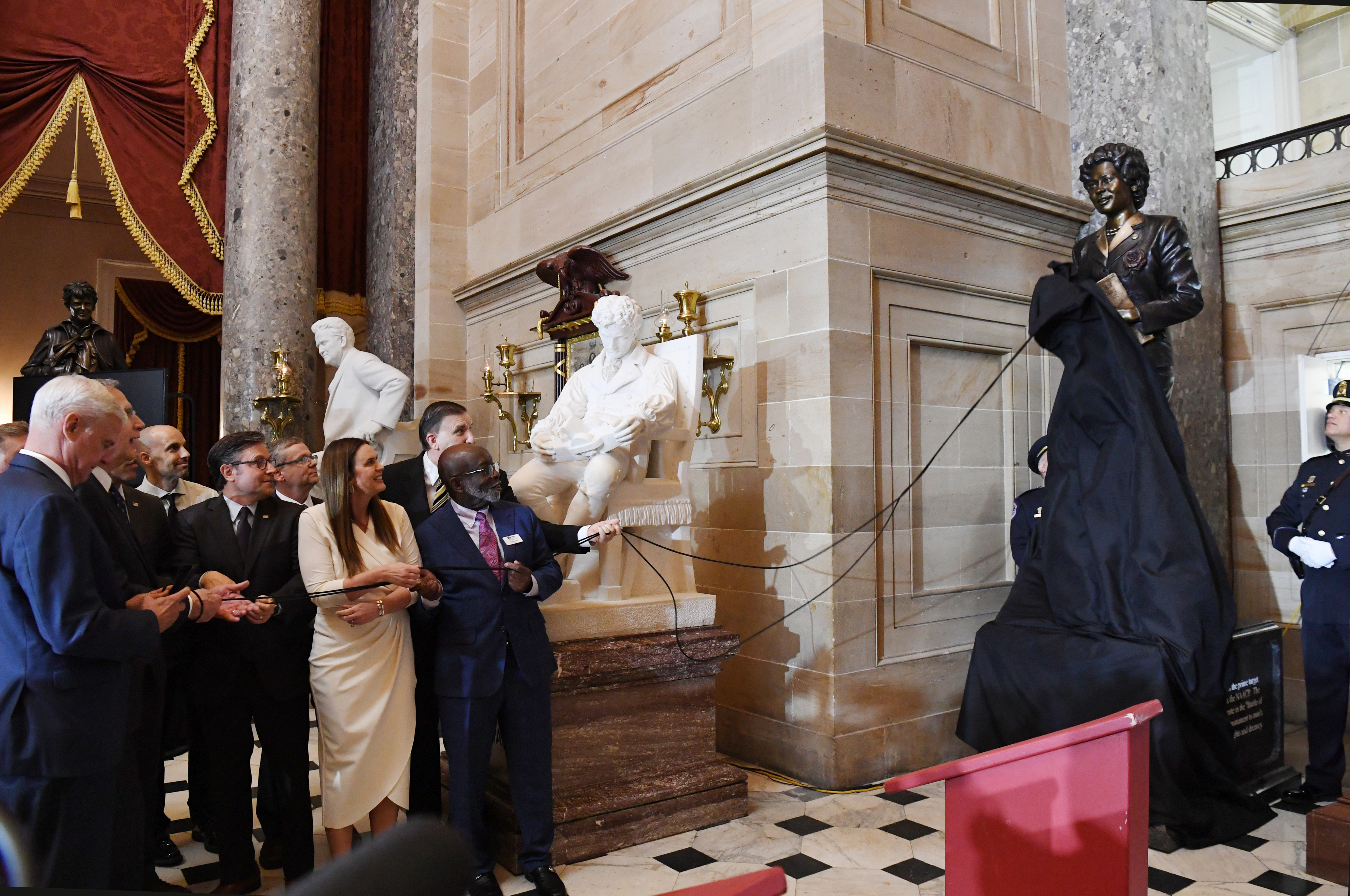 Dignitaries unveil the Daisy Lee Gaston Bates statue.