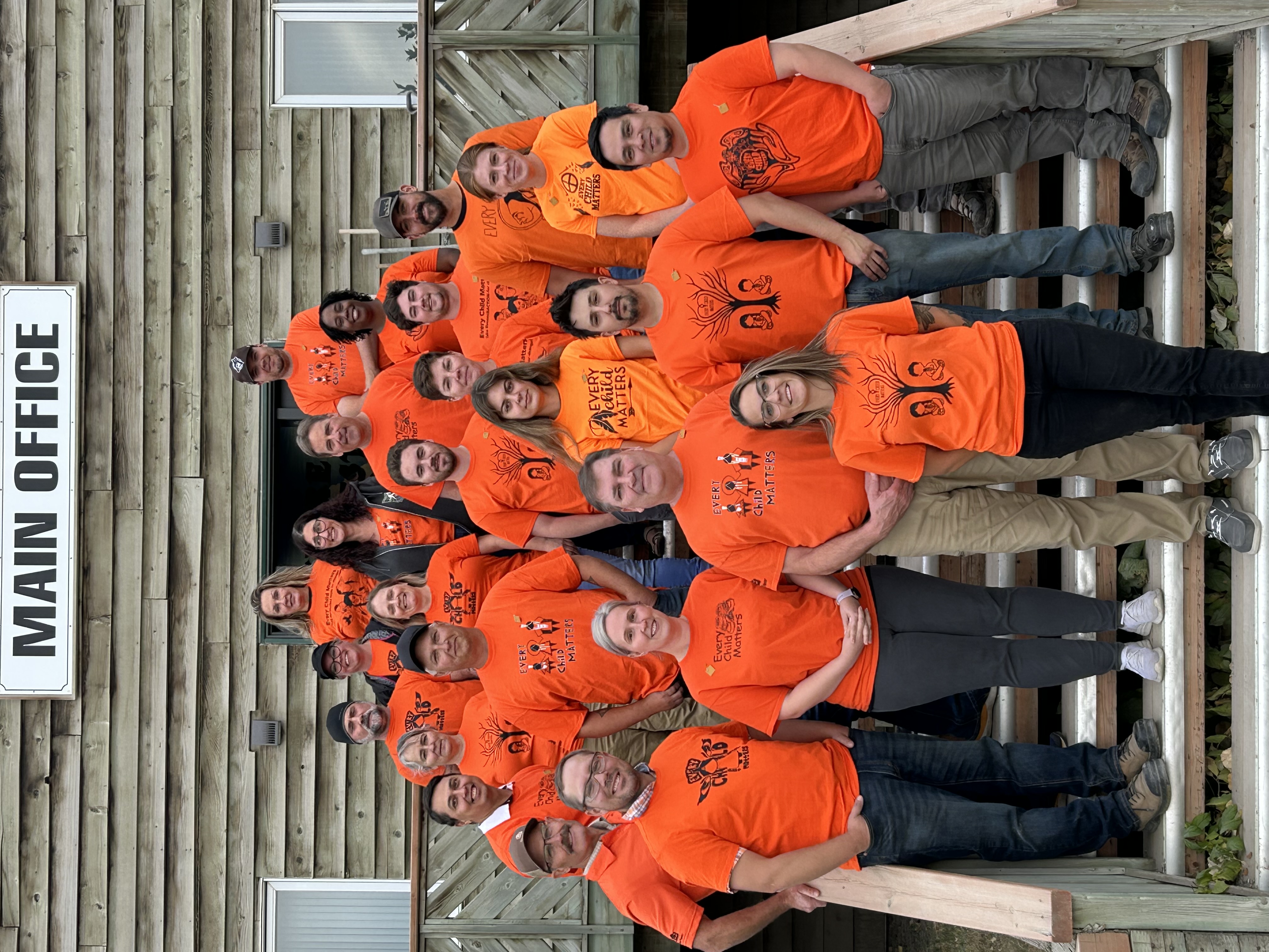 Sundre Forest Products employees gathered outside the main office in orange “Every Child Matters” shirts.