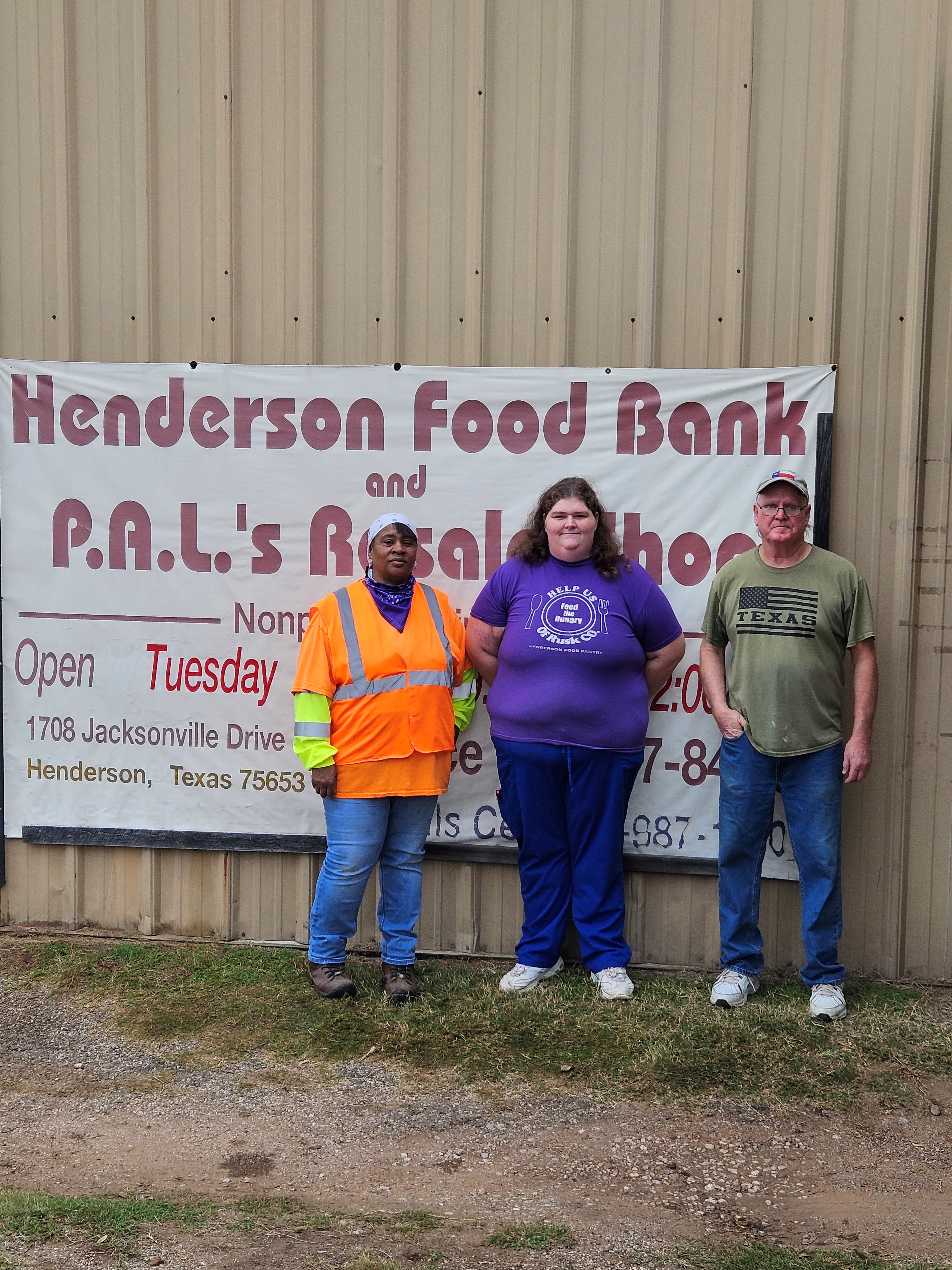 Sonja White (left) stands with representatives of the Henderson Food Pantry.