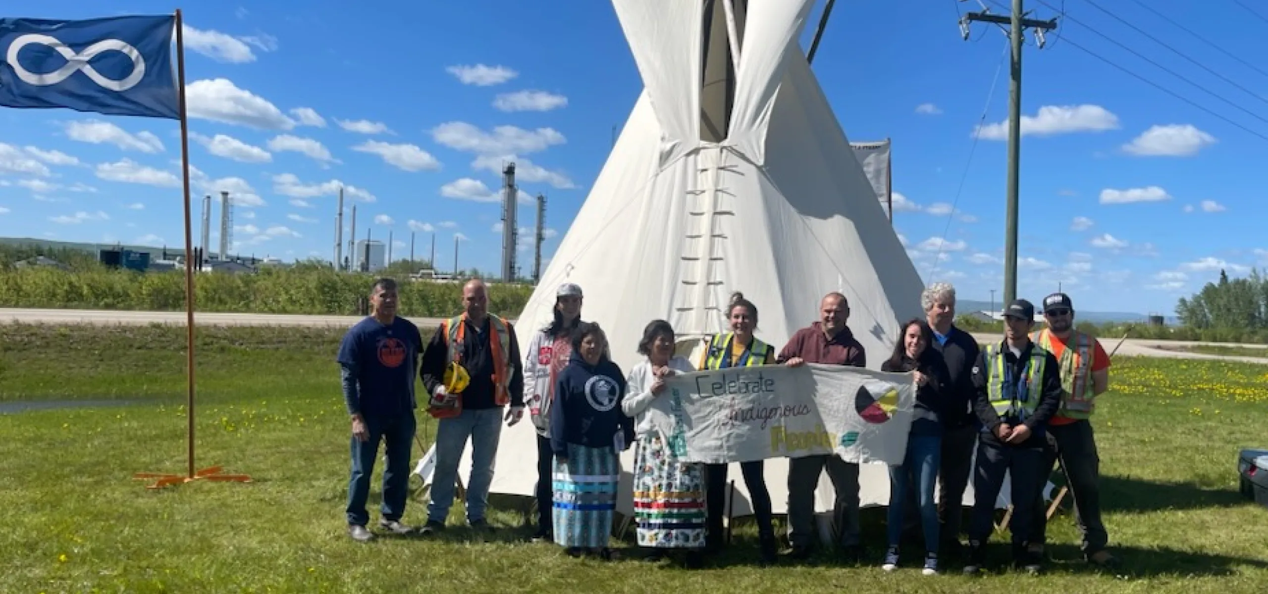 Slave Lake Veneer team members and Métis Nation of Alberta District 21 representatives stand in front of the newly erected tipi