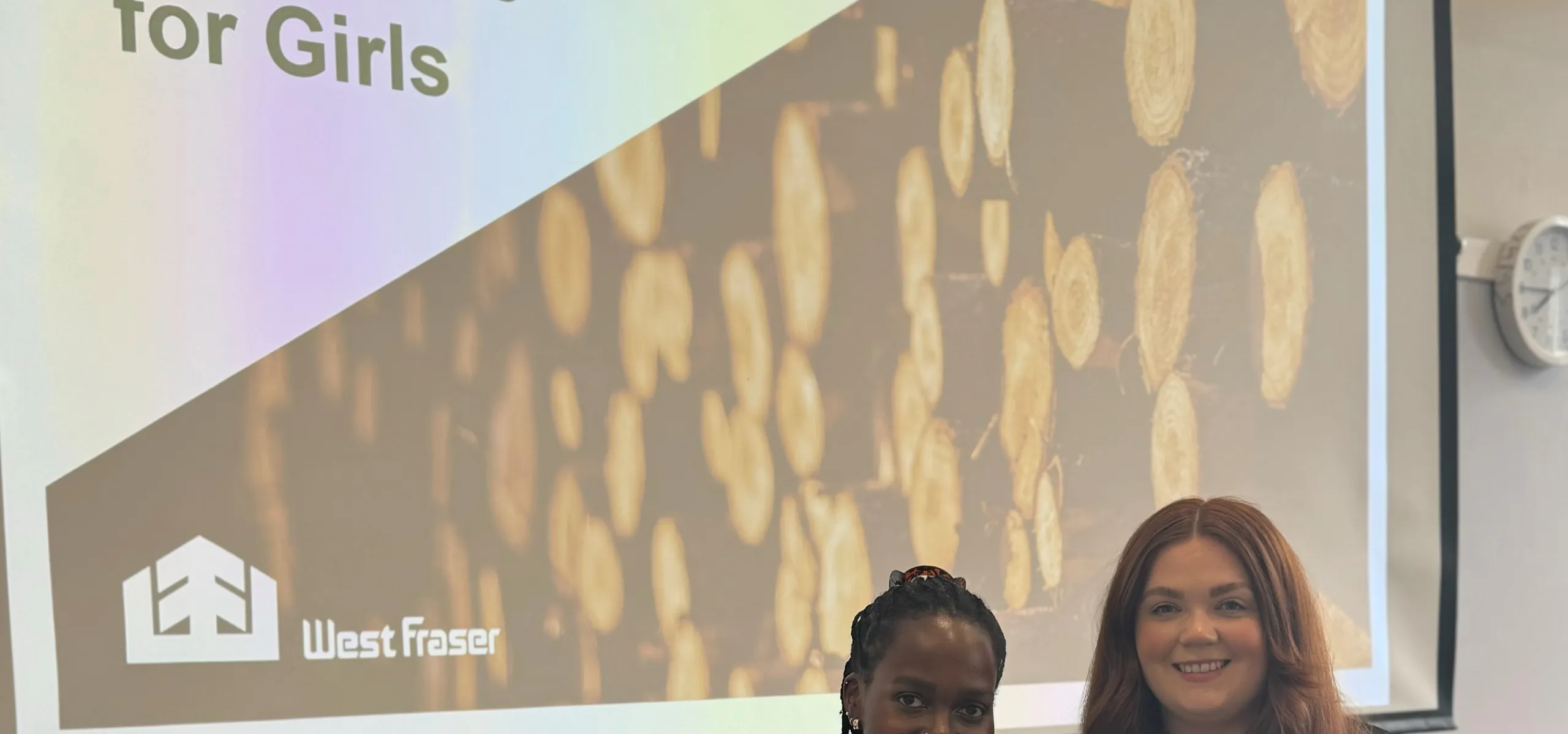 Two people in front of a screen