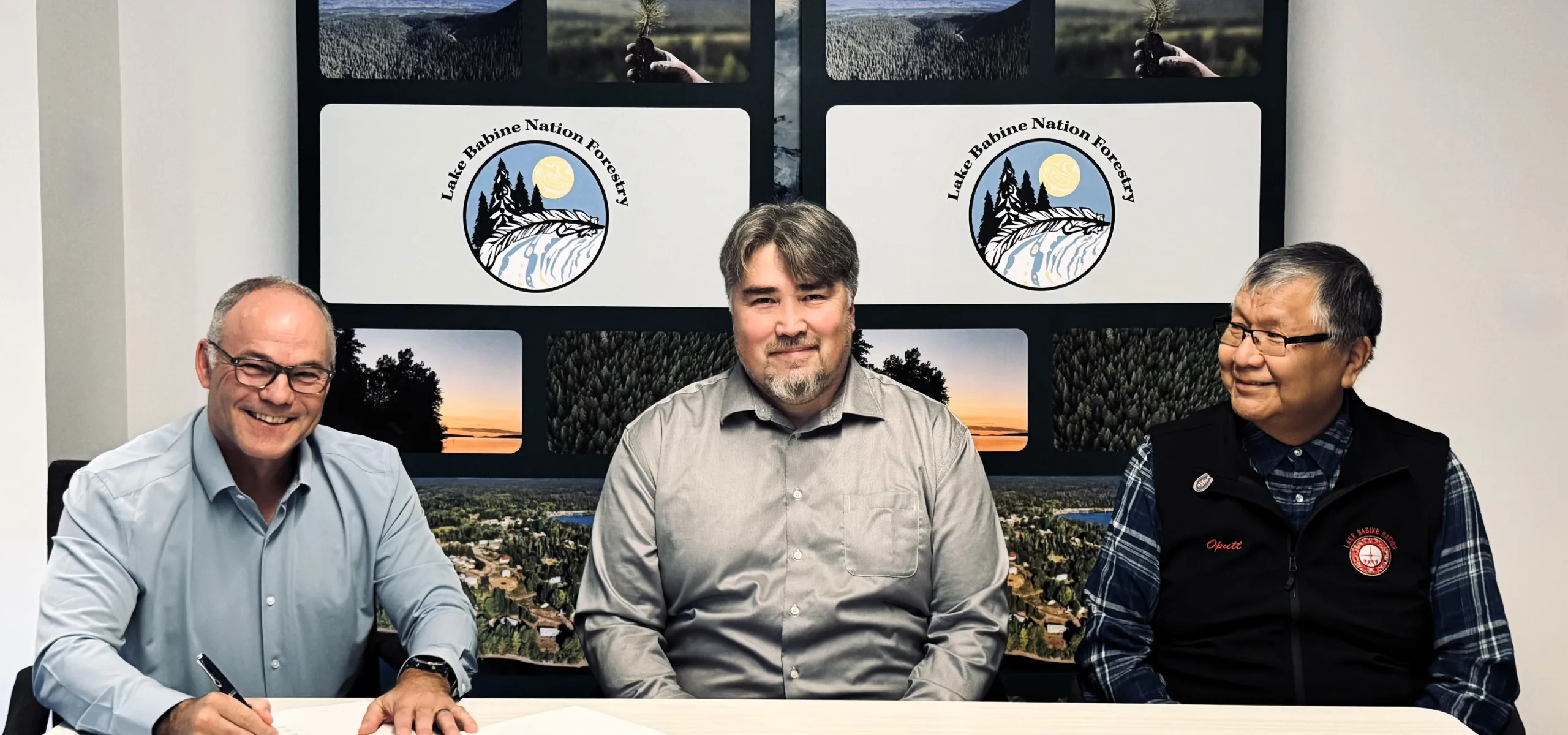 Pictured left to right, Sean McLaren, West Fraser; Duane Crouse, LBN Forestry; Wilf Adam, Chief, Lake Babine Nation sign agreement.