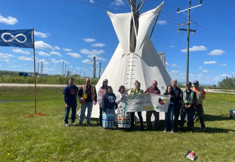 Slave Lake Veneer team members and Métis Nation of Alberta District 21 representatives stand in front of the newly erected tipi