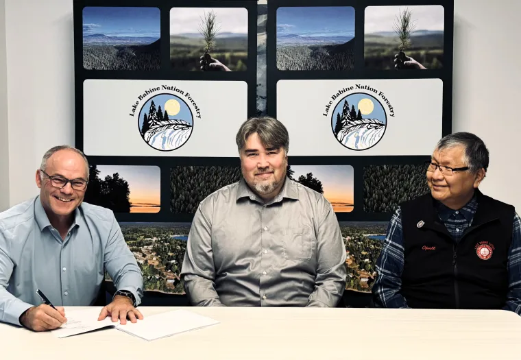 Pictured left to right, Sean McLaren, West Fraser; Duane Crouse, LBN Forestry; Wilf Adam, Chief, Lake Babine Nation sign agreement.