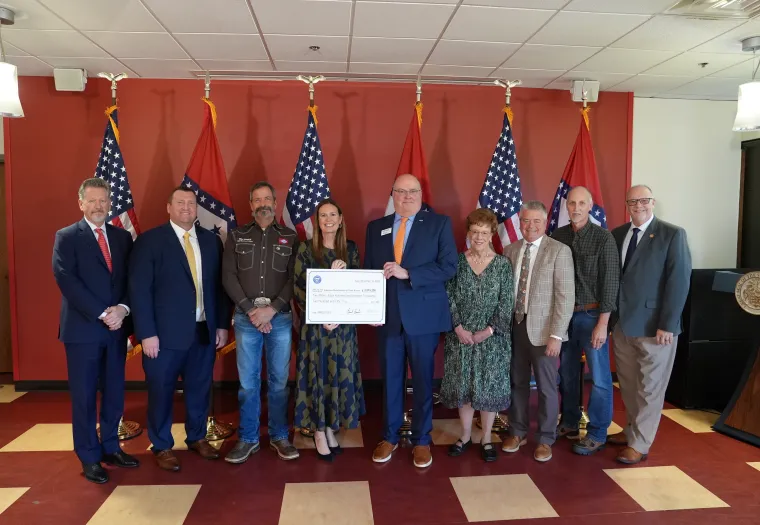 Thomas “Tony” Byrd, Corporate Maintenance Trainer, West Fraser (second from right), and Arkansas Governor Sarah Huckabee Sanders and Dr. Steve Rook, ASUTR Chancellor (centre with cheque), stand with representatives from other organizations who contributed to the HIRED grant program.