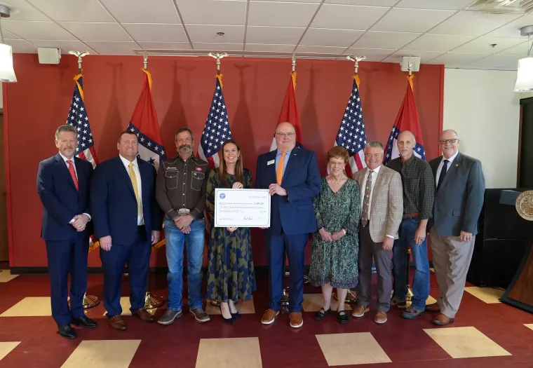 Thomas “Tony” Byrd, Corporate Maintenance Trainer, West Fraser (second from right), and Arkansas Governor Sarah Huckabee Sanders and Dr. Steve Rook, ASUTR Chancellor (centre with cheque), stand with representatives from other organizations who contributed to the HIRED grant program.