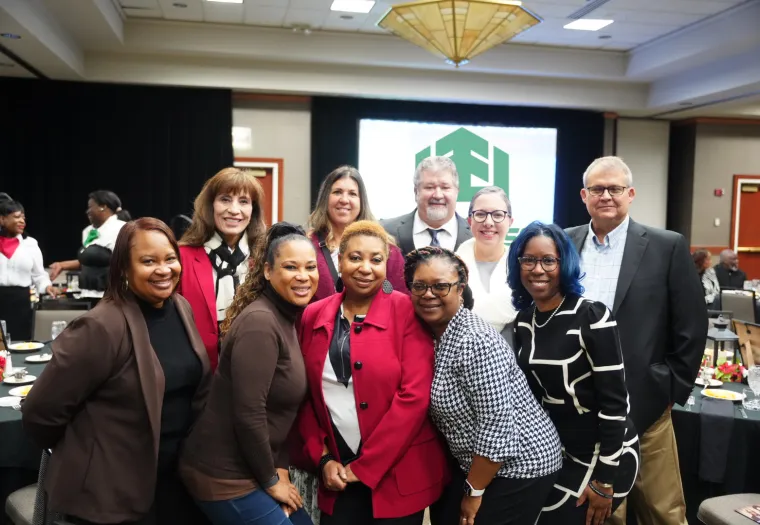 A group of people posing together indoors at the L.C. and Daisy Bates Black History Brunch event.