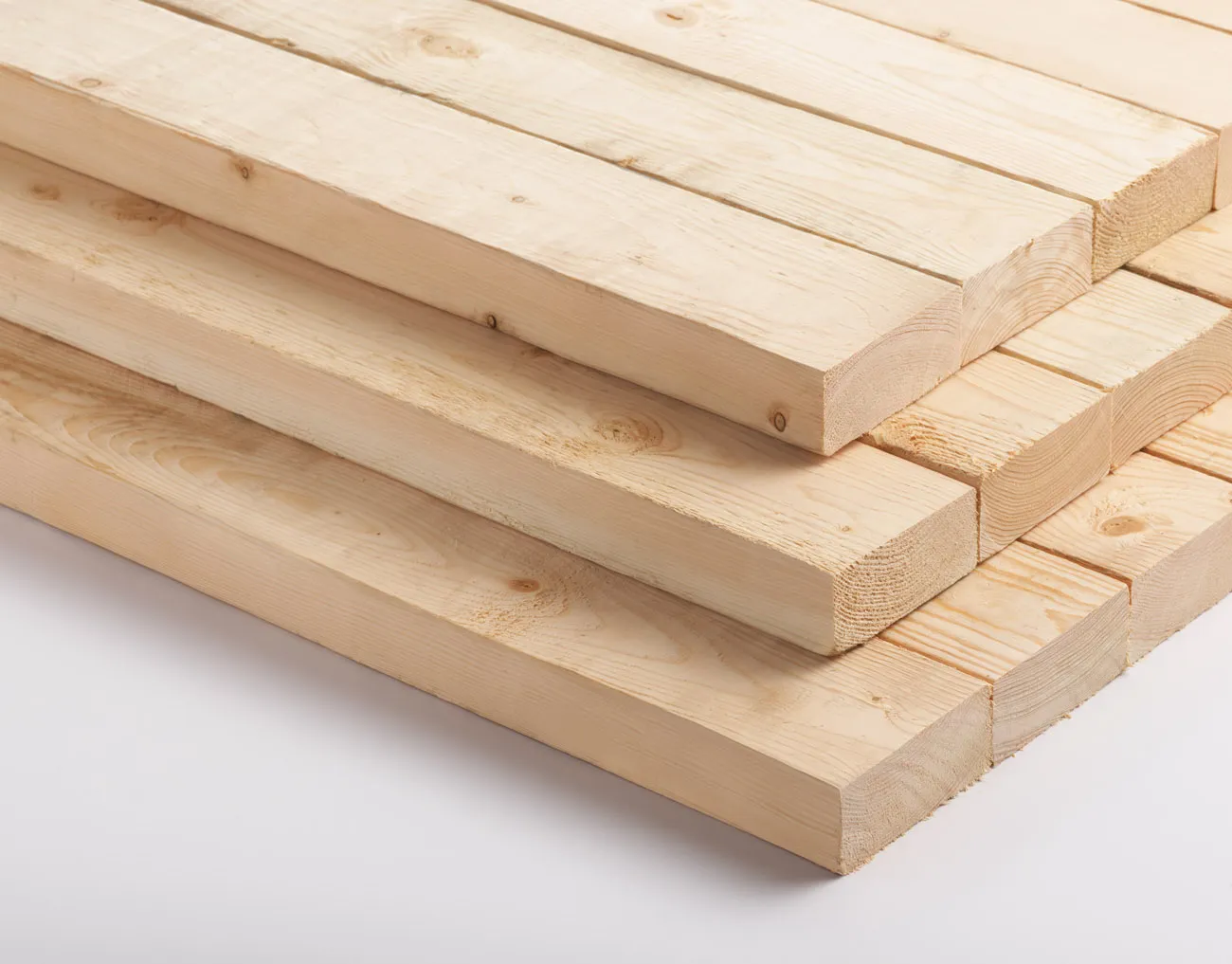 A stack of light-colored wooden planks neatly arranged on a white background.