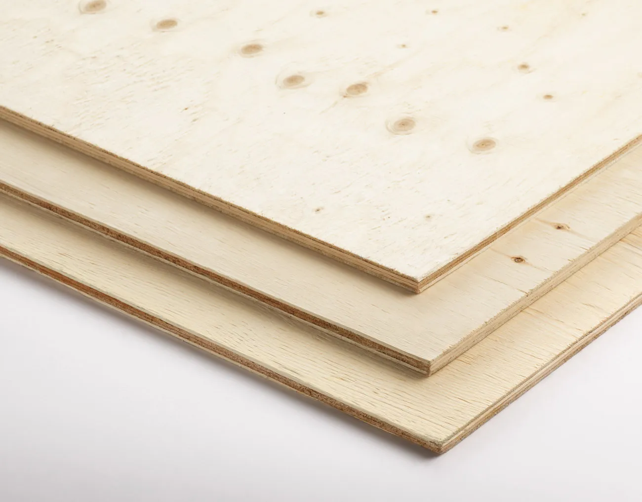 Stack of three sheets of plywood on a white background.