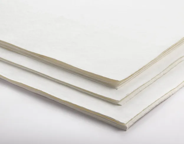 A stack of white paper sheets on a plain surface.