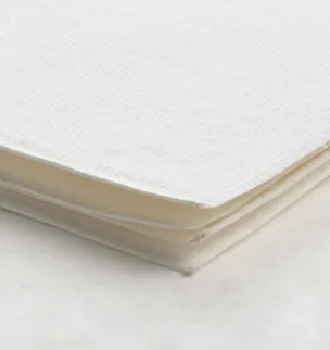 A stack of white paper napkins on a white surface.