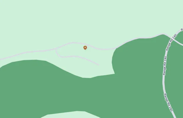Map showing a point of interest on a small road branching off Range Road 240. The area is mostly green, indicating vegetation or forest.