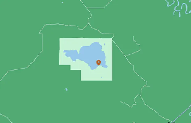 Map with a pin marking a location in a green area, with blue water bodies.