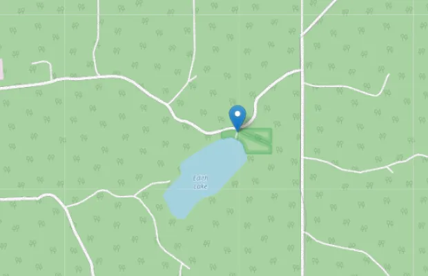 Map showing Edith Lake surrounded by forest, intersected by several winding roads, with a location pin marker at the lake's northern edge.