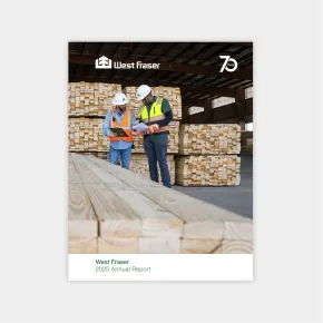 Two workers in safety gear examine documents in front of large stacks of lumber at a West Fraser facility, featured on the cover of the 2025 Annual Report.