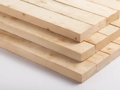 A stack of light-colored wooden planks neatly arranged on a white background.
