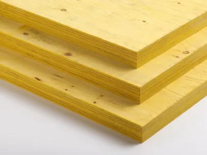Three stacked sheets of yellow plywood, viewed from the side.