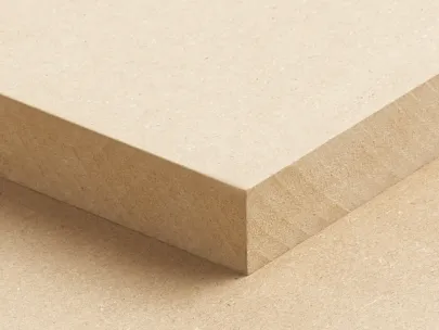 Close-up of a beige MDF board with a smooth surface and sharp edges, positioned diagonally against an identical board beneath it.