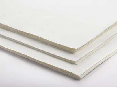 A stack of white paper sheets on a plain surface.