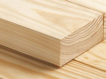 Close-up of stacked wooden planks with visible grain patterns on a light background.
